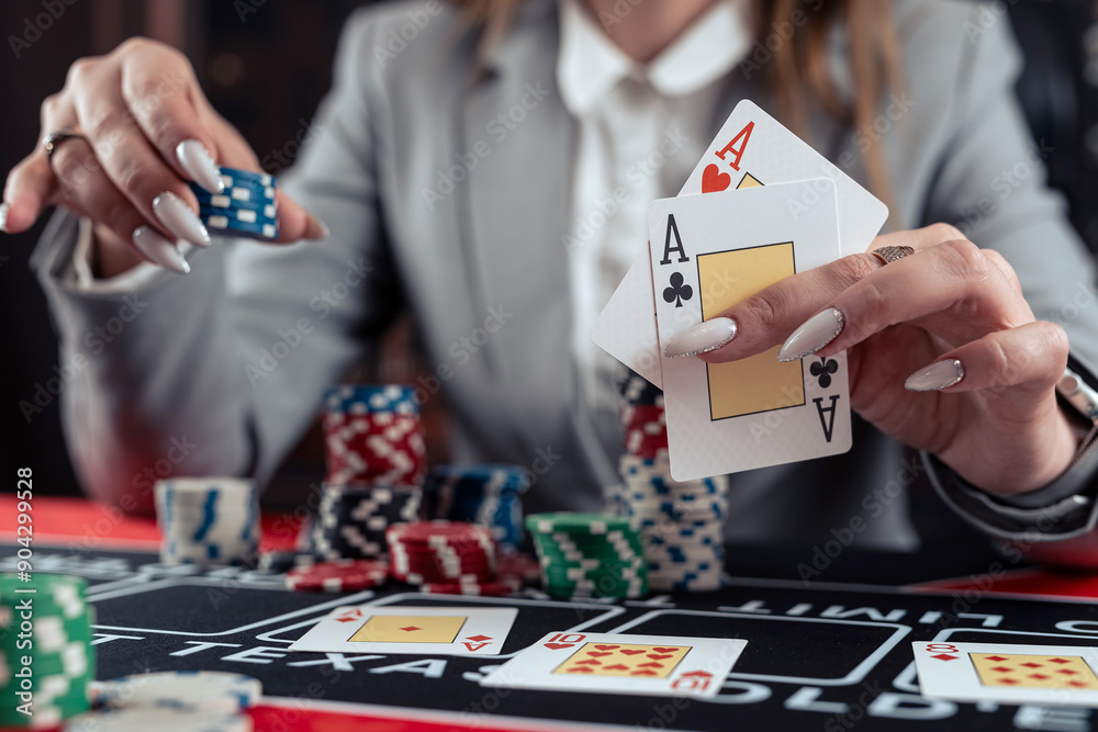 female player shows winning combination of two aces, win in casino poker