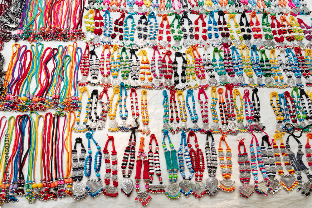 Traditional handmade multicolour fancy satin decorative Mala or necklace with plastic beads, selling at Sonajhuri haat at Shantiniketan, West Bengal Traditional handmade multicolour fancy satin decorative Mala or necklace with plastic beads, selling at Sonajhuri haat at Shantiniketan, West Bengal