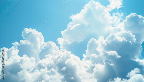 Fluffy white clouds float against a vibrant blue sky, creating a dreamy and serene atmosphere.