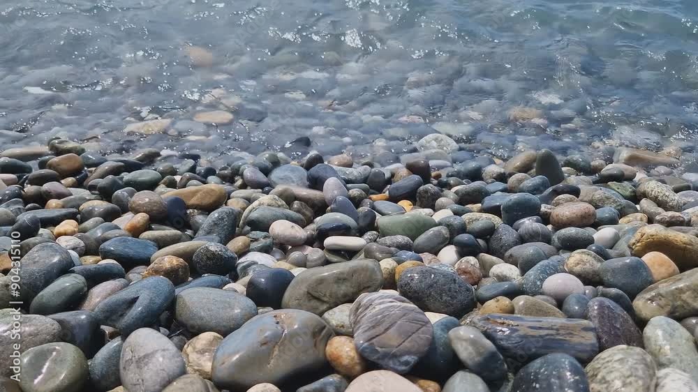 Waves break on the rocks on the beach, sea spray, sunlight is reflected in the water. Waves break on the rocks on the beach, sea spray, sunlight is reflected in the water.