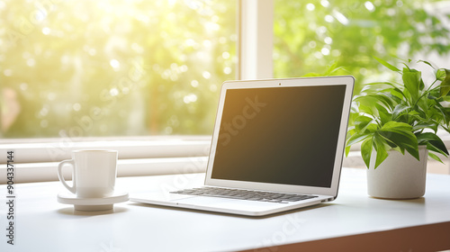 Bright Workspace with Laptop, Coffee Mug, and Plant by Window with Copy Space