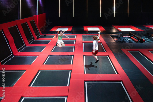 Friends enjoying an energetic day at a trampoline park photo