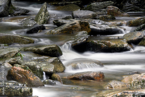 Flowing water over rocks background