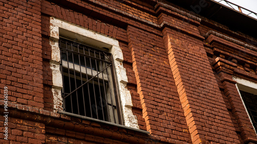 An Abandoned Brick Building featuring a Grated Window with an intriguing story behind it