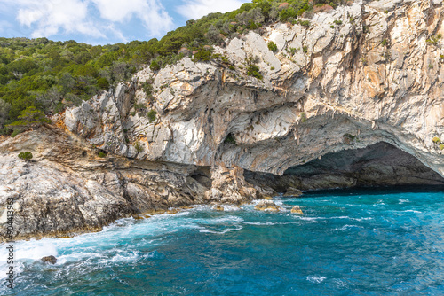 Explore the Meganisi Papanikolis Sea Cave in Lefkada island Greece, near Nydri on a boat cruise, blue sky and waves photo