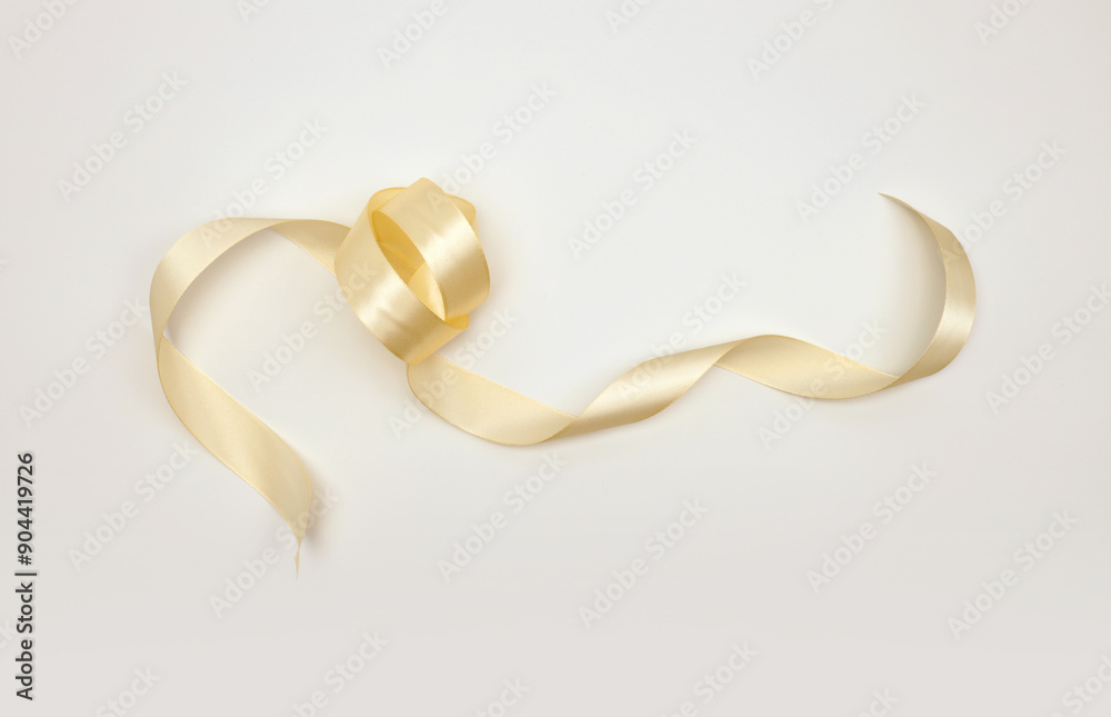 Beige color wave silk ribbon with light shadow on light background. Beige color wave silk ribbon with light shadow on light background.