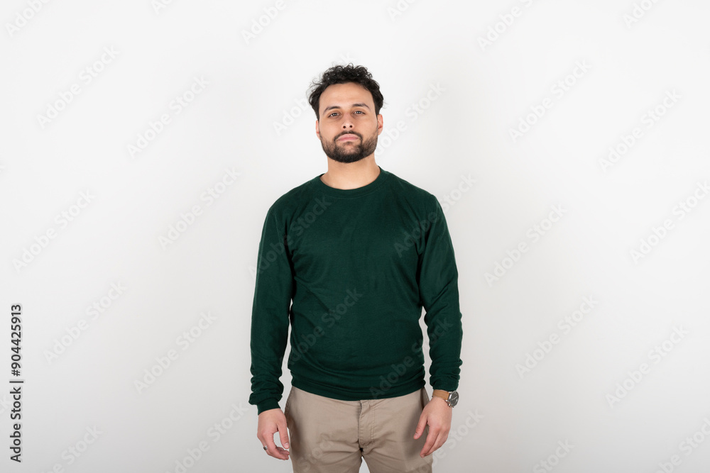 Portrait of young man with serene expression looking at the camera Portrait of young man with serene expression looking at the camera