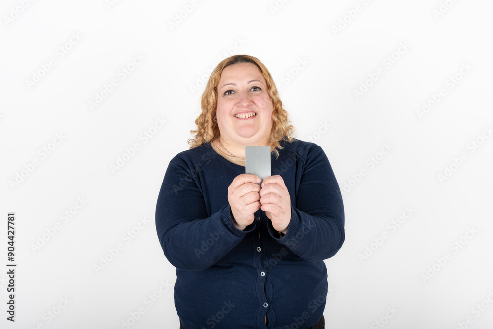 Woman smiling happily showing her credit card Woman smiling happily showing her credit card