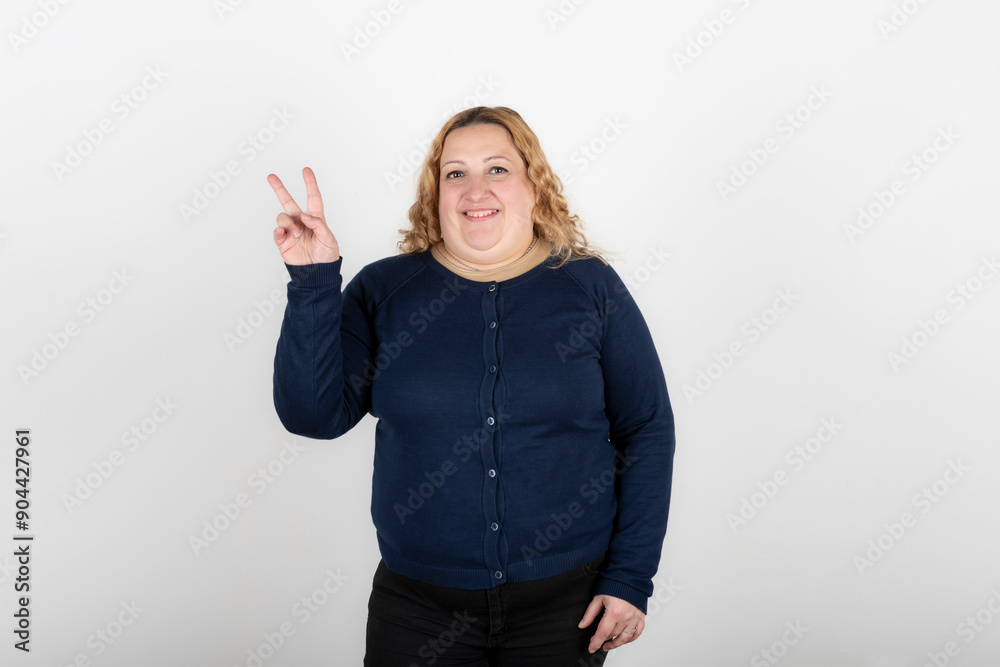 Happy woman making v for victory with her fingers Happy woman making v for victory with her fingers