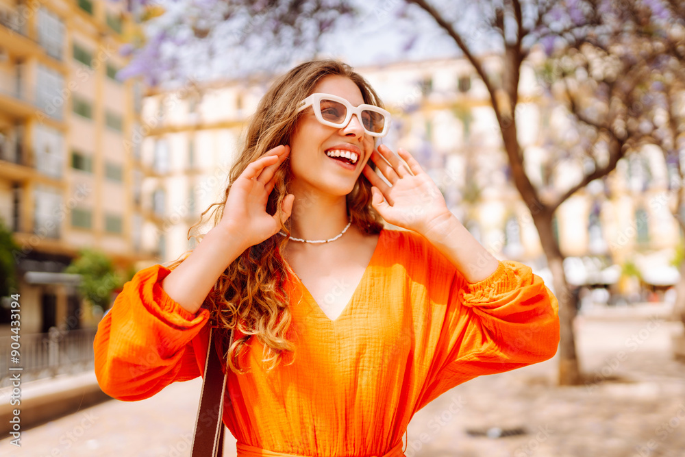 Smiling model posing in the street at sunny day. Fashionable female outdoors. Concept of lifestyle, vacation, style, travel. Smiling model posing in the street at sunny day. Fashionable female outdoors. Concept of lifestyle, vacation, style, travel.