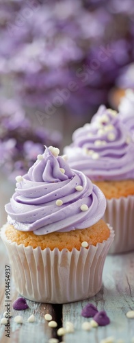 Delicious Purple Frosted Cupcakes on Wooden Table With Sprinkles