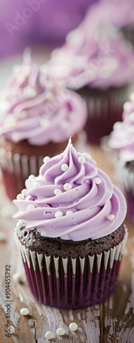Delicious Purple Frosted Cupcakes on Wooden Table With Sprinkles