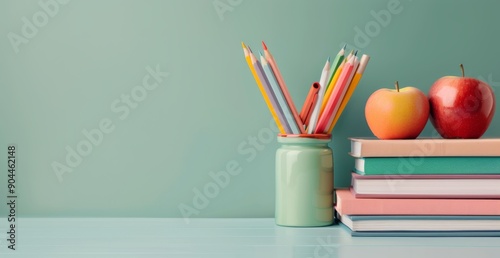 Colorful Pencils and Red Apples Resting on Stacked Books in Tranquil Setting
