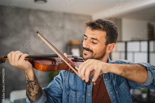 Adult man learn how to play violin practice at home