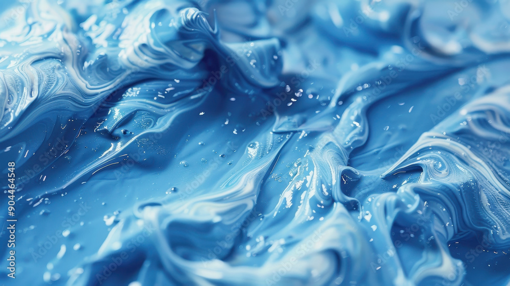 A splash of blue paint is captured in a photo, with the water droplets creating a sense of movement and energy. The image conveys a feeling of creativity and spontaneity