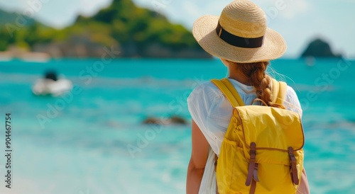 Woman in Yellow Backpack Stands by Tropical Beach With Clear Blue Water and I...