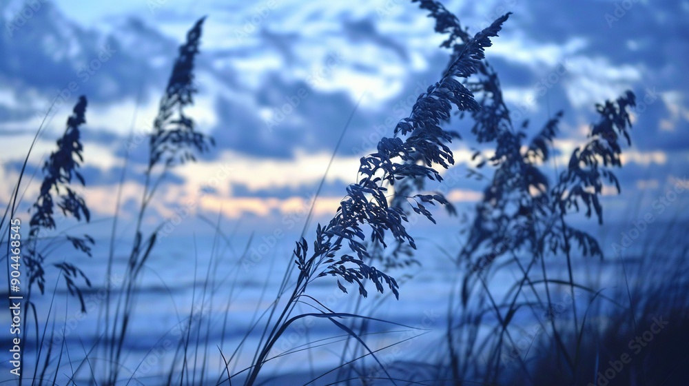 Obraz premium A detailed picture of a nearby plant beside water, under the open sky filled with cloudy skyscape
