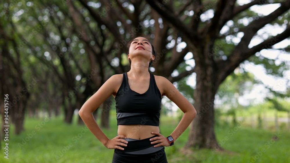 A woman is standing in a forest, looking up at the sky A woman is standing in a forest, looking up at the sky