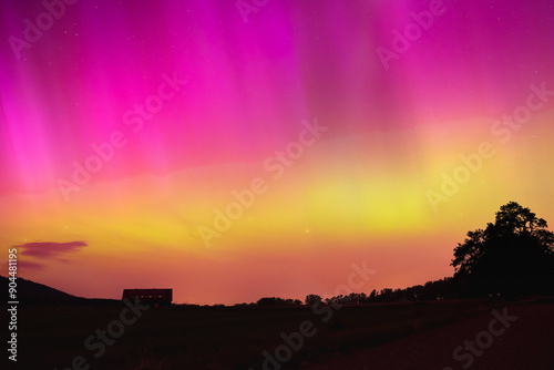 Aurora Borealis in Poland, a colorful show in the night sky, a light phenomenon in the mountain landscape.