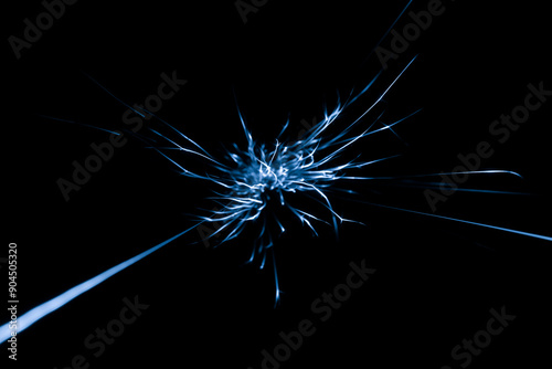 blue sparks from the grinder glowing in the dark