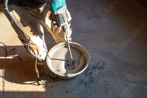 Mixing concrete liquid. Con...