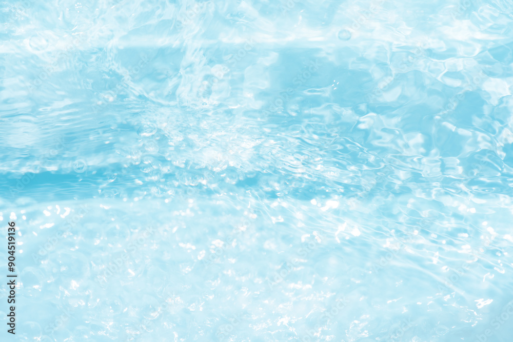 Blue water with ripples on the surface. Defocus blurred transparent blue colored clear calm water surface texture with splashes and bubbles. Water waves with shining pattern texture background. Blue water with ripples on the surface. Defocus blurred transparent blue colored clear calm water surface texture with splashes and bubbles. Water waves with shining pattern texture background.