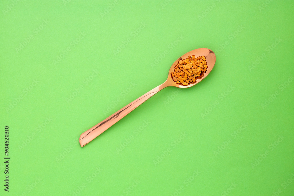Trigonella foenum-graecum - Natural aromatic fenugreek seeds in the spoon Trigonella foenum-graecum - Natural aromatic fenugreek seeds in the spoon