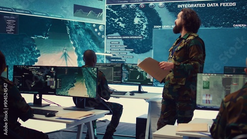 Fotografie Army major reads operation details from a case file in a control center military headquarters, manages personnel and resources for logistical or operational missions