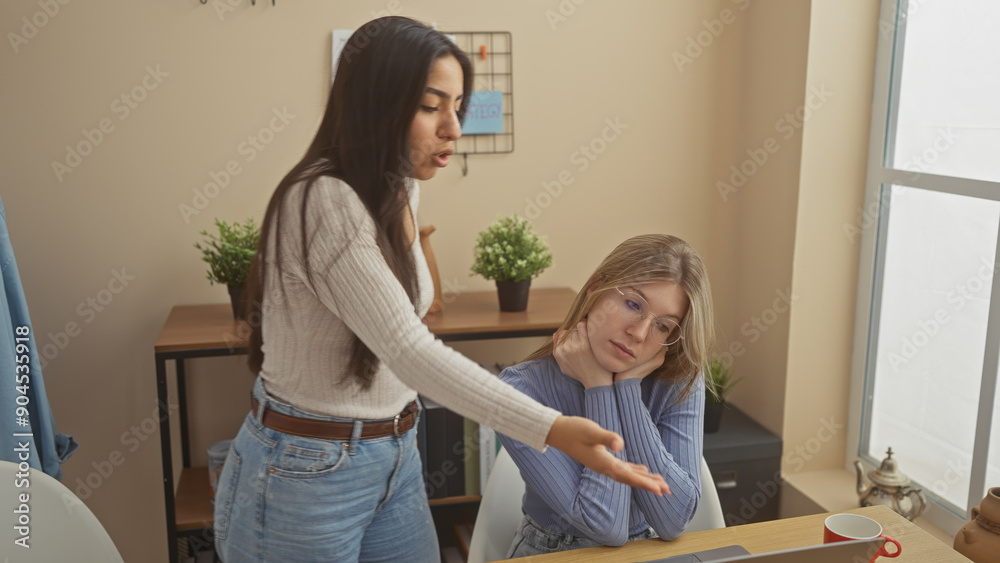 Two women in conversation in a cozy home office with modern decor, expressing a mix of attentiveness and casualness. Two women in conversation in a cozy home office with modern decor, expressing a mix of attentiveness and casualness.