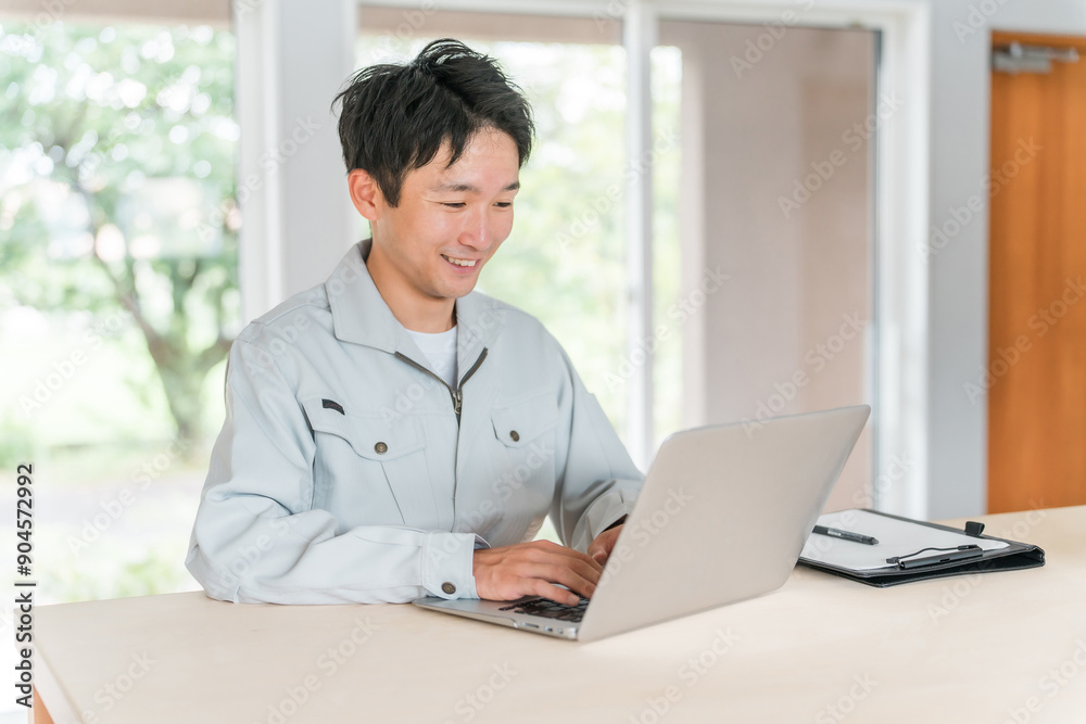 パソコン作業をする作業着・作業服姿の若いアジア人ビジネスマン
パソコン作業をする作業着・作業服姿の若いアジア人ビジネスマン