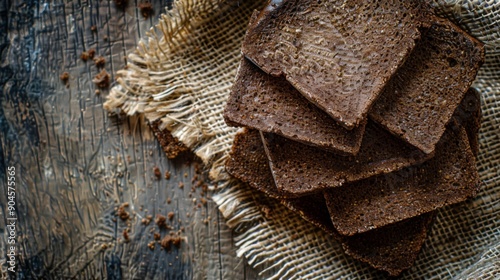 Top view of pumpernickel bread slices on a rustic tablecloth