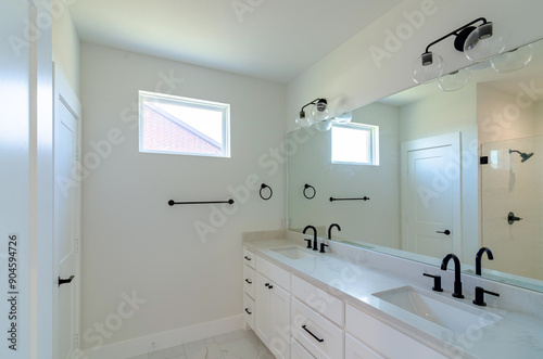 Bathroom with quartz countertop, black sink fixtures, white walls, mirror