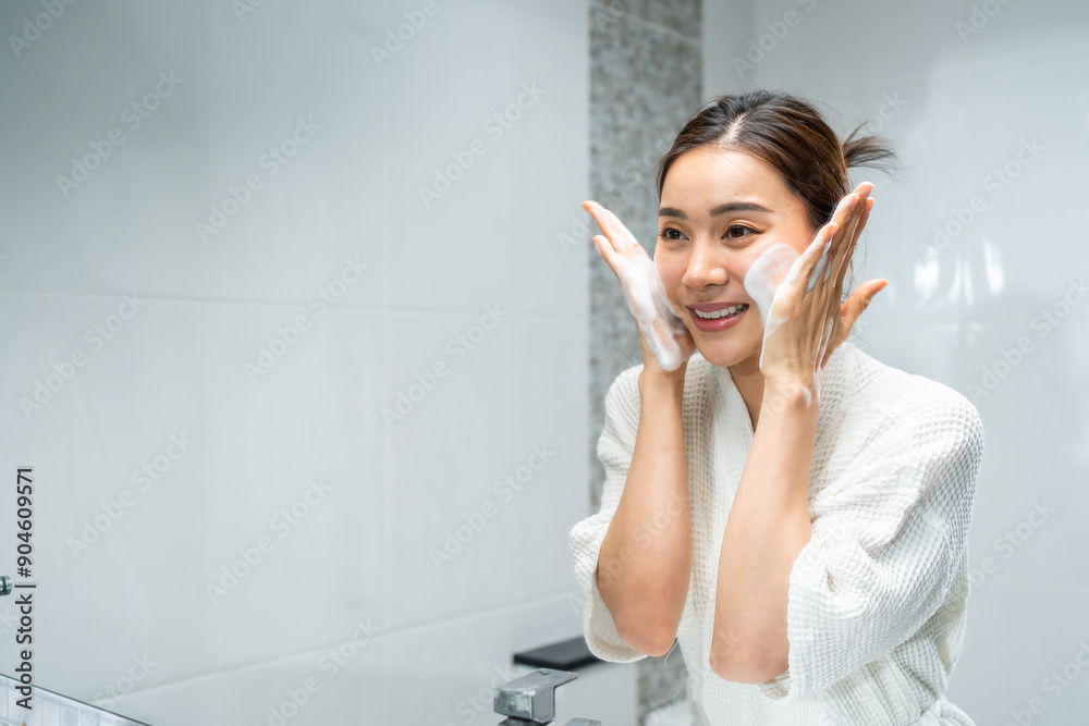 Asian beautiful woman washing her clean face with facial foam and water. Asian beautiful woman washing her clean face with facial foam and water.
