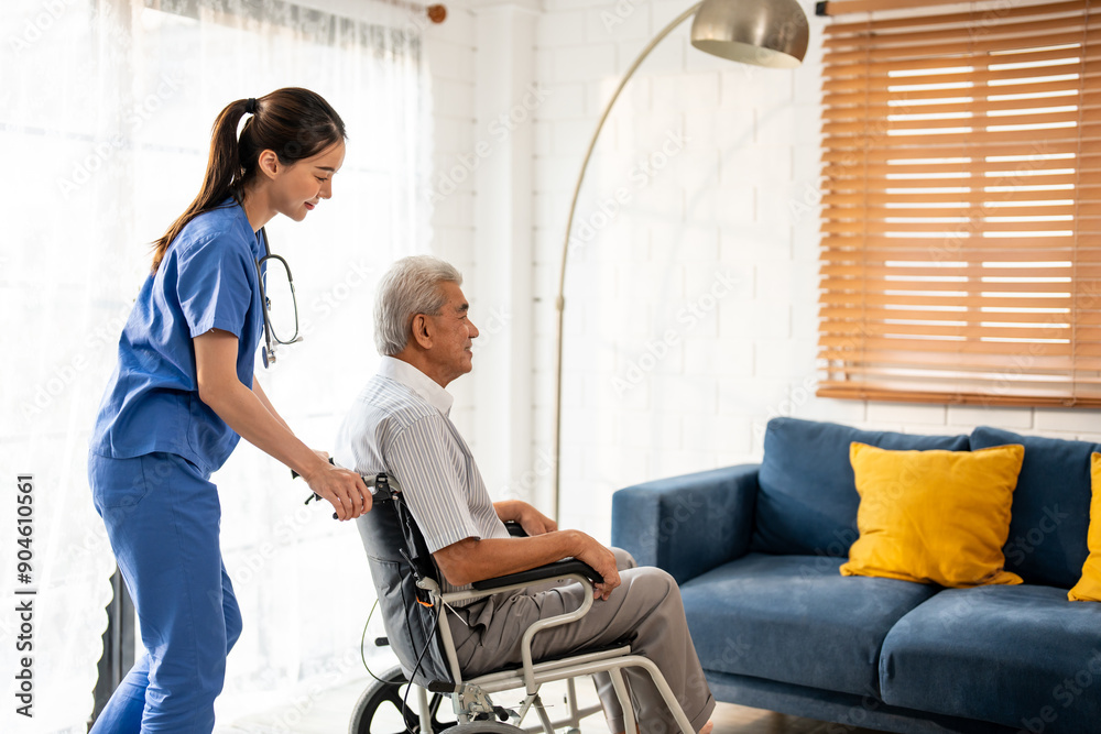 Asian young caregiver take care senior man on wheelchair in house. Asian young caregiver take care senior man on wheelchair in house.