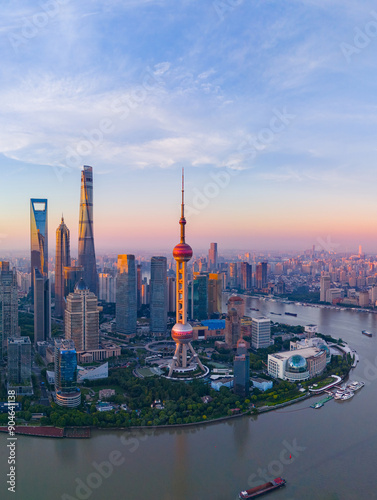 Aerial view of modern city skyline and buildings at sunrise in Shanghai.