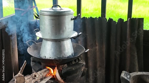 The double boiler cooking on bonfire