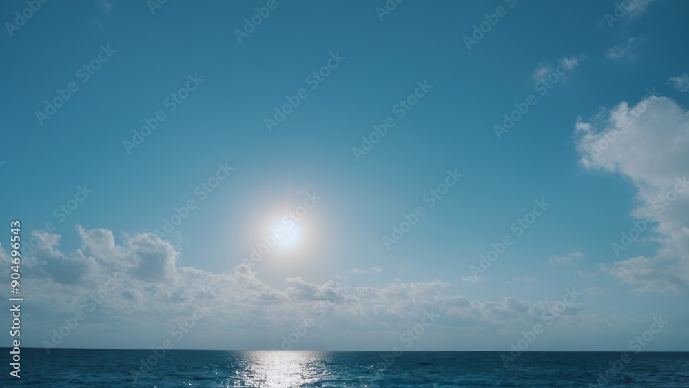 Fototapeta premium the sun is shining over the ocean under some clouds,