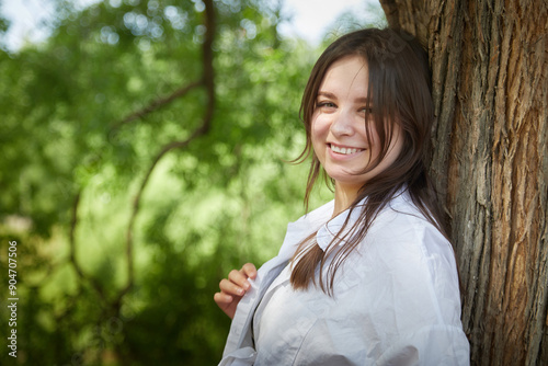 Portrait of a happy girl in the park in summer. Holidays, rest, youth