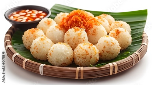 typical Indonesian food onde onde with toppings on a bamboo plate and banana leaves on a white background