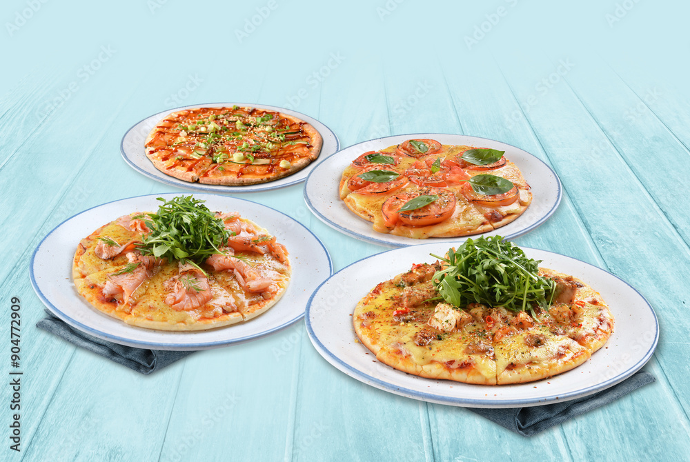assorted baked hot vegetarian margherita and tomato basil chicken sausage salmon cheese round pizza on white table western vegetarian pastry cuisine halal food hotel luxury cafe menu set combo