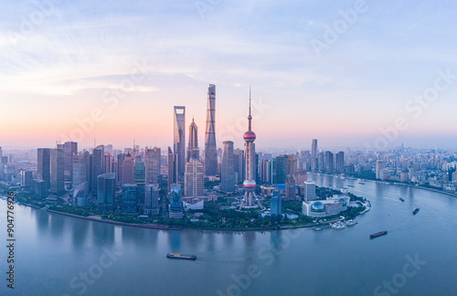 Aerial view of modern city skyline and buildings at sunrise in Shanghai.