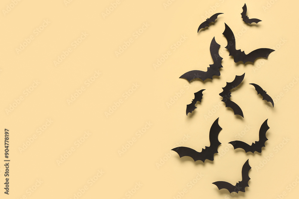 Fototapeta premium Paper bats for Halloween party on yellow background