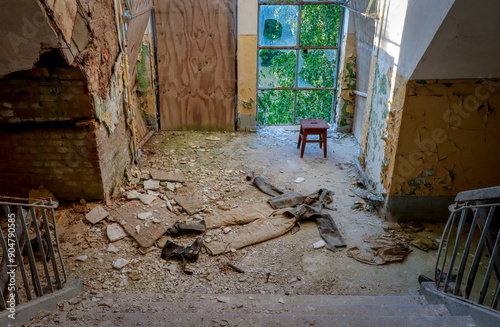 old military clothes and a chair in an abandoned barracks