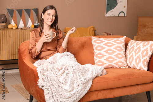 Young woman with cup of tea...