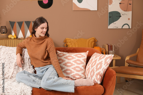Happy young woman sitting a...