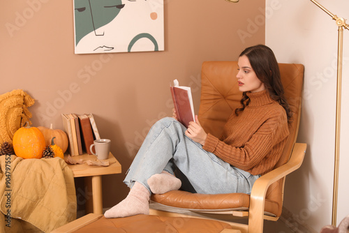 Young woman reading book in...