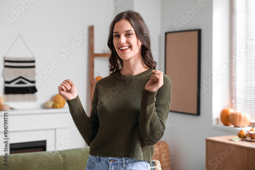 Smiling young woman at home...