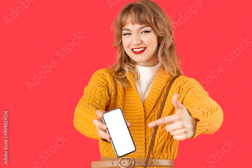 Stylish young woman pointin...