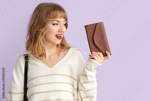Young woman with wallet on ...