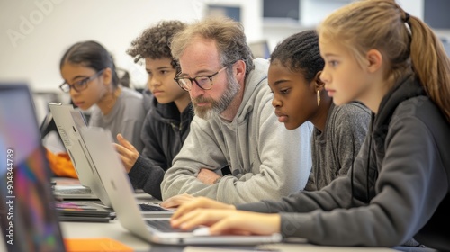 Creative Collaboration: Students and Teacher Working on Digital Media Project